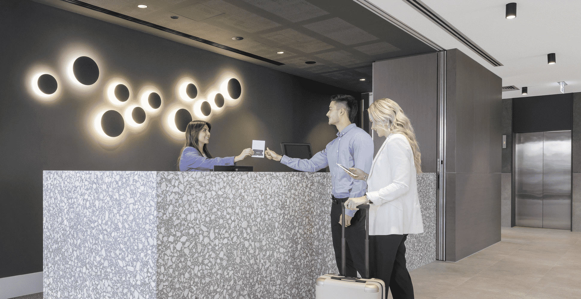 Two people checking out at reception